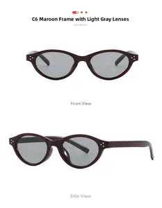 Macro detail of wine red oval sunglasses with grey lenses and silver stud accents