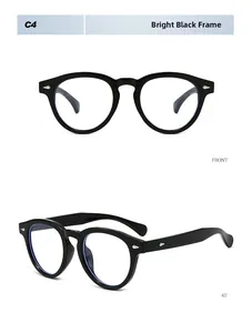 Close-up of bright black Boston frame eyeglasses with silver arrow rivet detailing