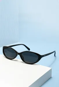 Detail of cat eye sunglasses with metal accents on white geometric stand