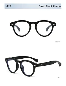 Detail of round sand black retro frame with silver diamond rivets and blue light lens