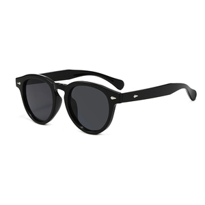 Classic round oversized black sunglasses with silver arrow rivets and dark lenses