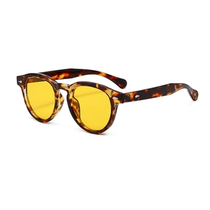 Vintage round tortoiseshell sunglasses with yellow lenses and silver rivets for women