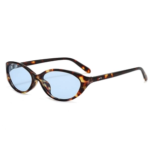 Retro cat-eye sunglasses with tortoiseshell frame and light blue lenses in a side view