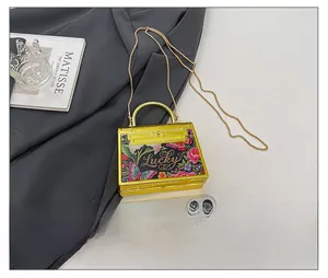 Mini acrylic Kelly bag with floral Lucky pattern compared to smartphone for size
