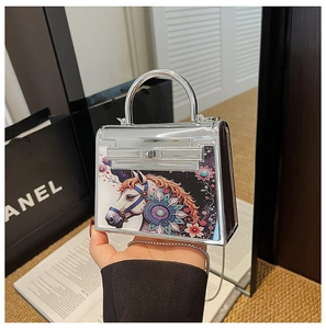 Close-up of silver mirror mini Kelly bag with horse print and mandala floral design