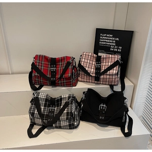 Detailed display of vintage plaid and solid canvas crossbody bags in four color options