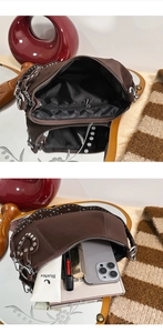 Detailed internal view of vintage studded bag showing storage capacity for phone and cosmetics
