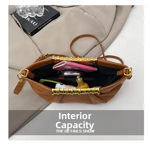 Interior view showing spacious storage capacity of the brown ruched crossbody bag