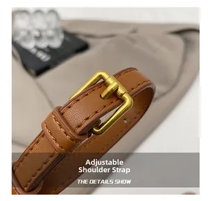 Detail of adjustable brown lychee leather shoulder strap with vintage gold buckle