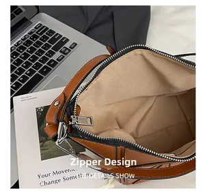 Detail view of the secure zipper closure and premium hardware on the geometric bucket bag