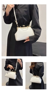 Detail of white woven crossbody bag featuring gold metal frame and double bead clasp