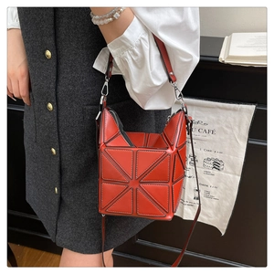 Macro detail of red geometric bucket bag with high-quality synthetic leather and silver hardware