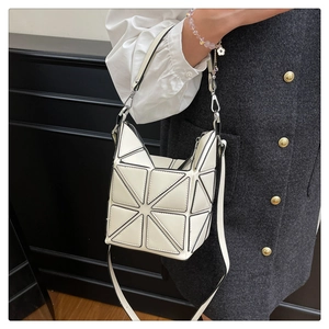 Detail view of white geometric bucket bag with signature triangular patchwork design