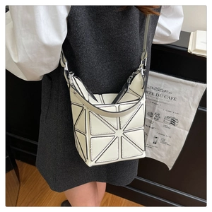 Detail of geometric bucket bag in cream white PU leather with adjustable shoulder strap