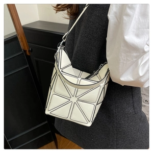 Detailed view of the white geometric triangular panel design on a stylish crossbody bucket bag