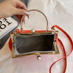 Retro red leather evening bag with golden floral handle and pearl clasp detail