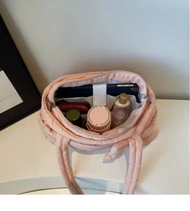 Internal view of pink quilted tote bag showing spacious capacity and tablet compartment