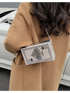 Close-up of Ace of Spades evening bag with silver and black rhinestones and chain strap