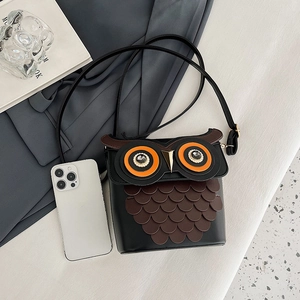 Quirky owl-shaped bucket bag in black PU leather with creative feather detail and strap
