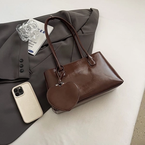 Minimalist large brown glossy tote bag with heart charm for commuting lifestyle