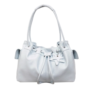 Detail of light blue drawstring tote bag showing star charms and side pocket texture