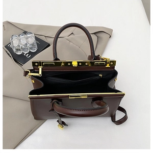 Detail showing deep brown leather doctor bag interior with golden hardware and zipped pocket