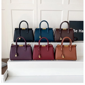 Collection of minimalist leather handbags in six colors with elegant gold twist-lock closure