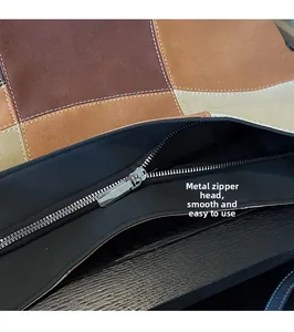Detail of high-quality silver zipper and smooth hardware pull on contrast tote bag