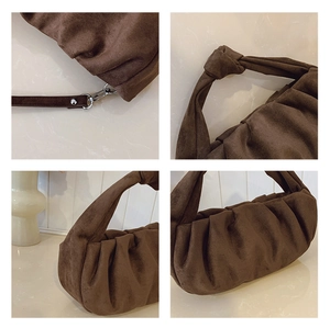 Macro shot of dark brown ruched bag detailing metallic hardware and knotted handle design