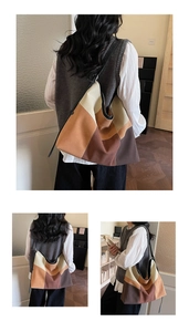 Detail of color-block tote bag featuring geometric stitching and soft Hobo design