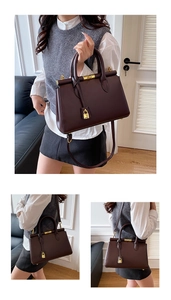 Close-up of a burgundy structured leather handbag with elegant gold hardware and padlock