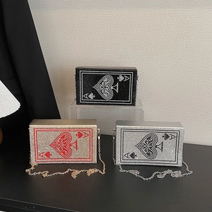 Sparkling rhinestone evening bags with Ace of Spades poker design in gold, silver, and black