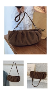 Detail showing brown pleated cloud bag textures and versatile carrying options