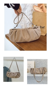 Detailed view of beige pleated cloud bag with matte texture and adjustable strap