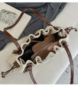 Detail view of large drawstring tote bag with荔枝 grain and spacious interior space