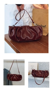 Detail of dark burgundy pleated cloud bag showing glossy wax leather texture and strap