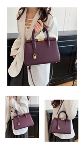 Deep purple leather trapezoid handbag shown from front and side view with gold hardware
