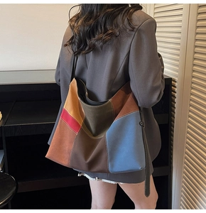 Detail of color-block patchwork tote bag featuring high-quality suede texture and hobo style