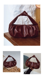 Detail of dark reddish-brown pleated cloud bag with elegant knotted handle design