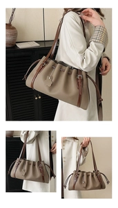 Macro detail of oatmeal leather bucket bag featuring drawstring tassels and silver buckle
