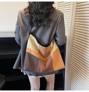 Retro large-capacity patchwork canvas hobo shoulder bag shown on a model's back