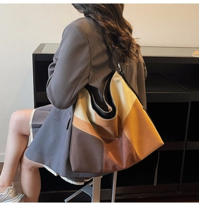 Detailed stitching on oversized color-block hobo bag with earth tones for women