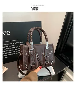Close-up of coffee brown retro satchel with metal rivets and adjustable strap details