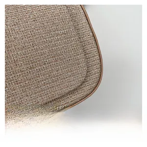 Close-up of champagne sequin fabric and smooth edge stitching on a luxury handbag