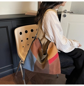 Detail of color-block canvas tote bag worn on shoulder for stylish daily commuting