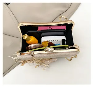 Internal view of champagne clutch bag showing space for phone and makeup accessories