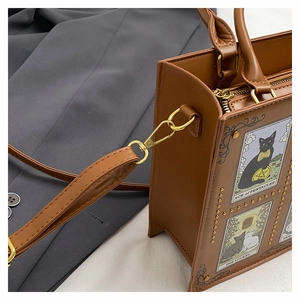 Detail of vintage brown tote bag with cat tarot prints and adjustable shoulder strap