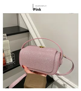 Detailed macro view of a pink sequin crossbody box bag with gold metal hardware details