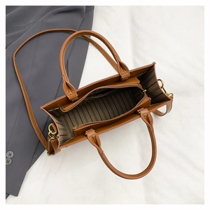 Top view of brown tote bag showing striped lining, zipper pocket and spacious interior