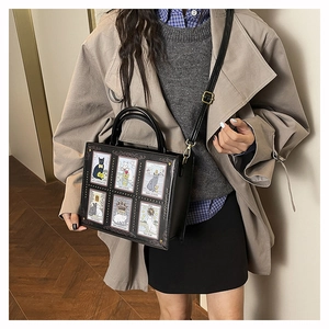 Detail shot of a black cat tarot print crossbody bag paired with a classic trench coat